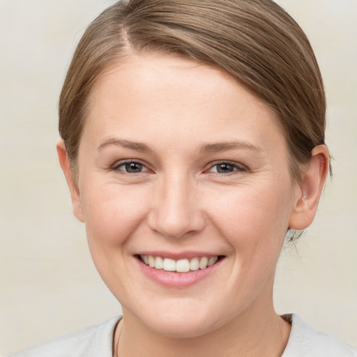 Joyful white young-adult female with medium  brown hair and brown eyes