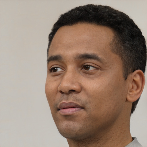 Neutral latino adult male with short  black hair and brown eyes