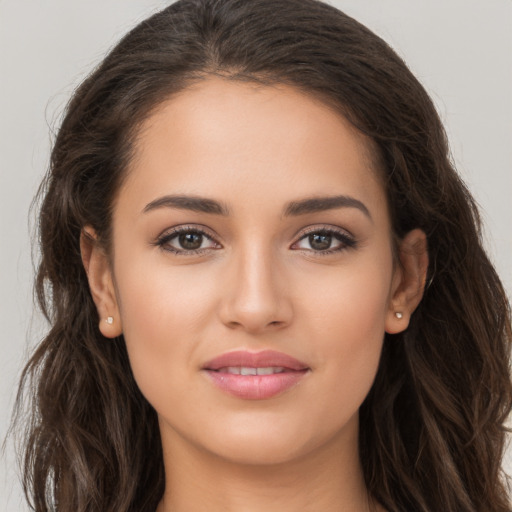 Joyful white young-adult female with long  brown hair and brown eyes