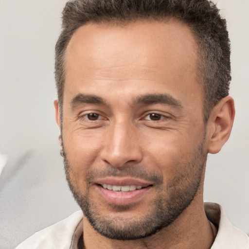 Joyful white adult male with short  brown hair and brown eyes