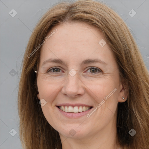 Joyful white adult female with long  brown hair and brown eyes