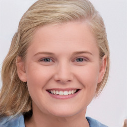 Joyful white young-adult female with medium  brown hair and blue eyes