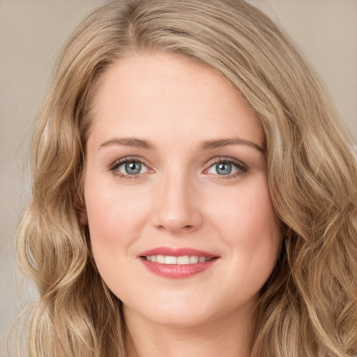 Joyful white young-adult female with long  brown hair and blue eyes