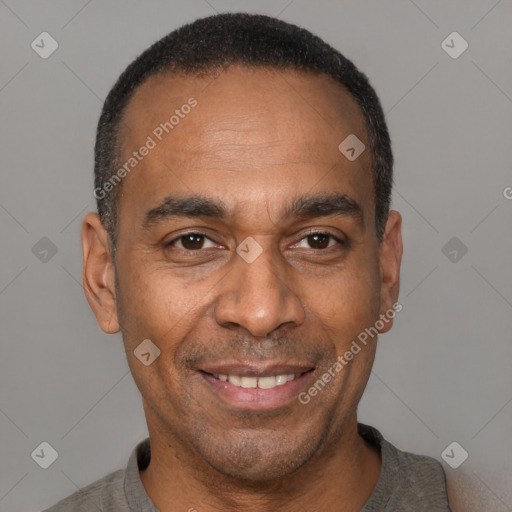 Joyful latino adult male with short  black hair and brown eyes