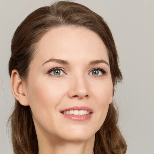 Joyful white young-adult female with medium  brown hair and green eyes