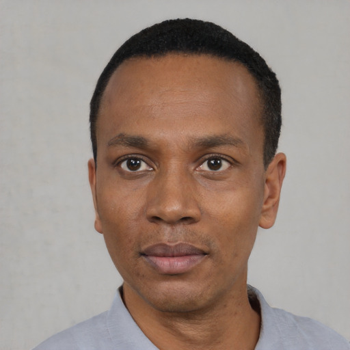 Neutral black adult male with short  black hair and brown eyes