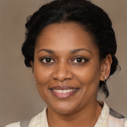 Joyful black adult female with medium  brown hair and brown eyes