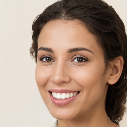 Joyful white young-adult female with long  brown hair and brown eyes