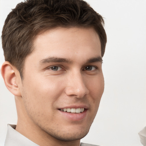 Joyful white young-adult male with short  brown hair and brown eyes