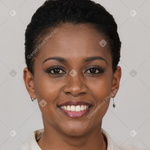 Joyful black young-adult female with short  brown hair and brown eyes