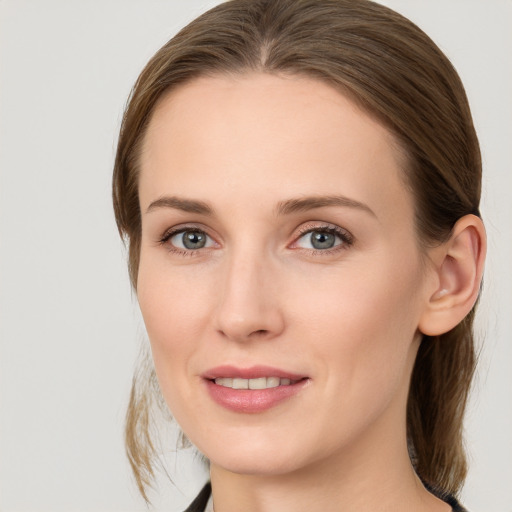 Joyful white young-adult female with medium  brown hair and grey eyes