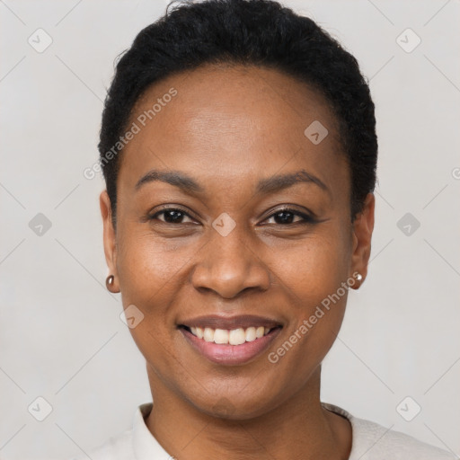 Joyful black young-adult female with short  black hair and brown eyes