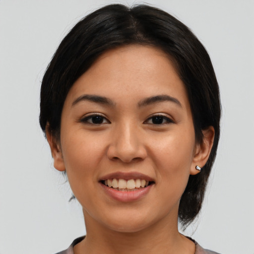 Joyful latino young-adult female with medium  black hair and brown eyes