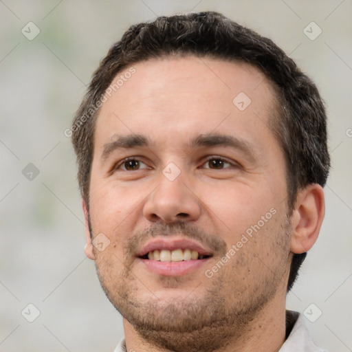 Joyful white adult male with short  brown hair and brown eyes