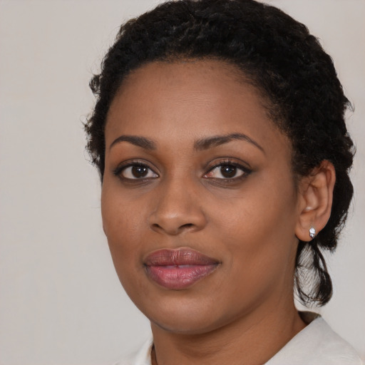 Joyful black young-adult female with medium  brown hair and brown eyes