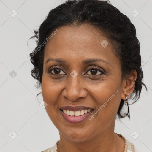 Joyful black adult female with short  brown hair and brown eyes