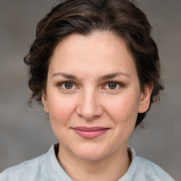 Joyful white adult female with medium  brown hair and grey eyes