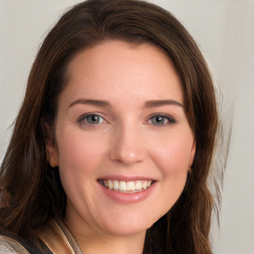 Joyful white young-adult female with long  brown hair and blue eyes