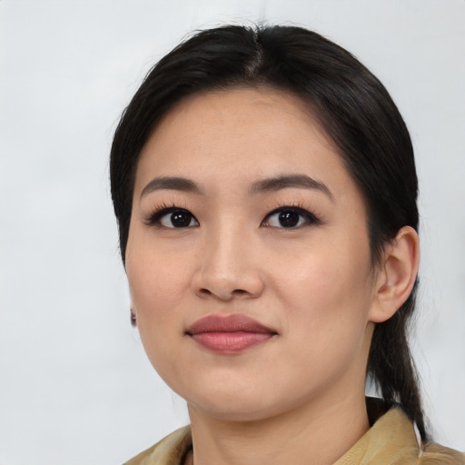 Joyful asian young-adult female with medium  black hair and brown eyes