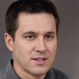 Joyful white adult male with short  brown hair and brown eyes