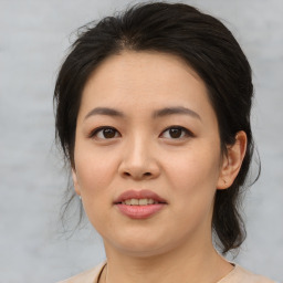 Joyful asian young-adult female with medium  brown hair and brown eyes