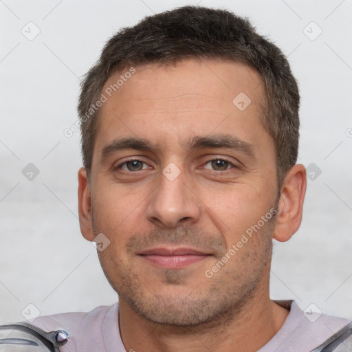 Joyful white adult male with short  brown hair and brown eyes