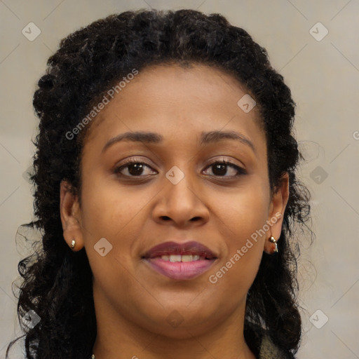 Joyful black young-adult female with long  brown hair and brown eyes