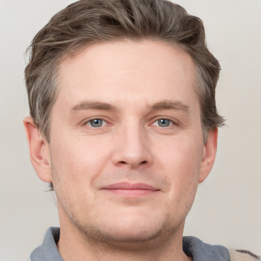 Joyful white adult male with short  brown hair and grey eyes