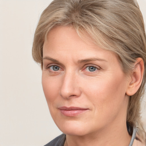 Joyful white adult female with medium  brown hair and grey eyes