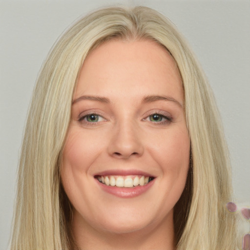 Joyful white young-adult female with long  blond hair and blue eyes