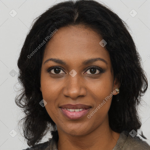 Joyful black young-adult female with long  brown hair and brown eyes