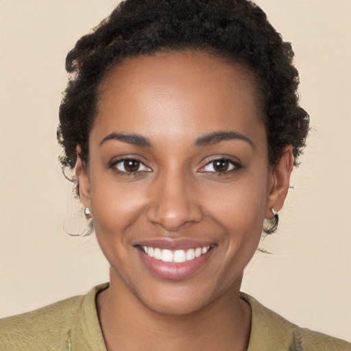 Joyful black young-adult female with short  brown hair and brown eyes