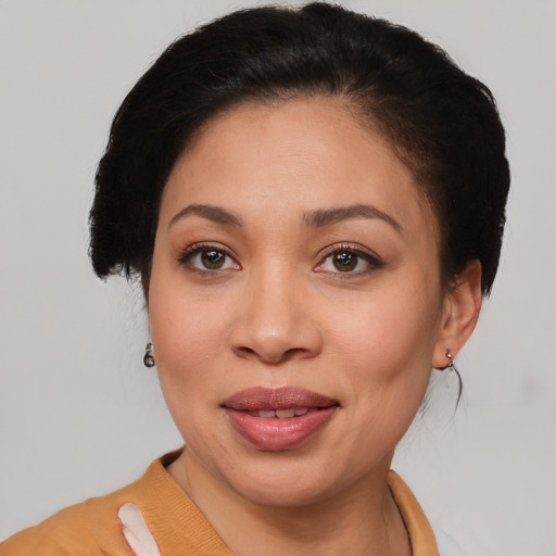 Joyful latino adult female with short  brown hair and brown eyes