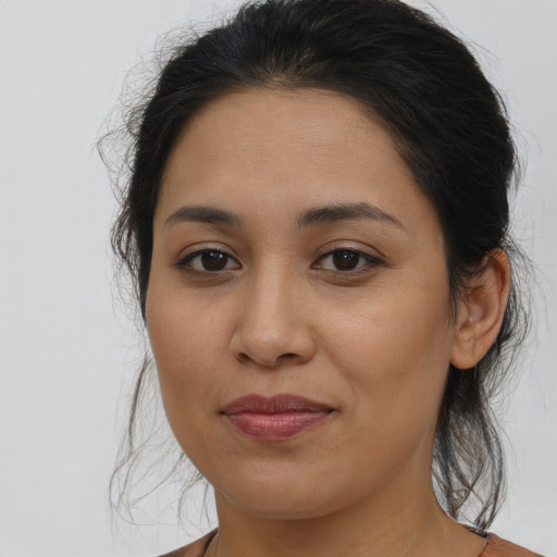 Joyful latino young-adult female with medium  brown hair and brown eyes