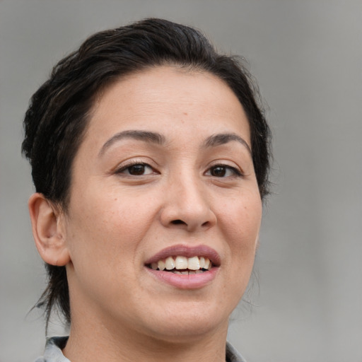 Joyful white adult female with medium  brown hair and brown eyes