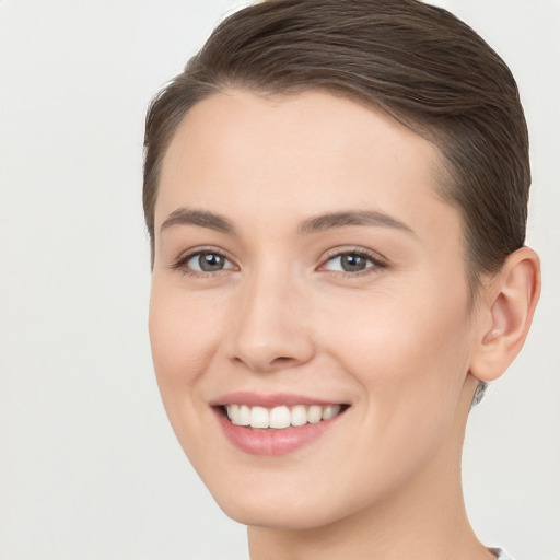 Joyful white young-adult female with short  brown hair and brown eyes