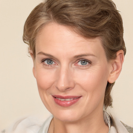 Joyful white adult female with medium  brown hair and grey eyes