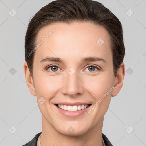 Joyful white young-adult female with short  brown hair and grey eyes