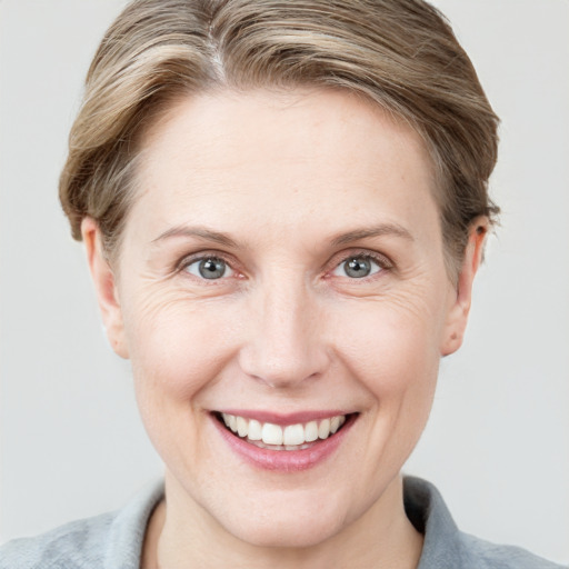 Joyful white adult female with short  brown hair and grey eyes