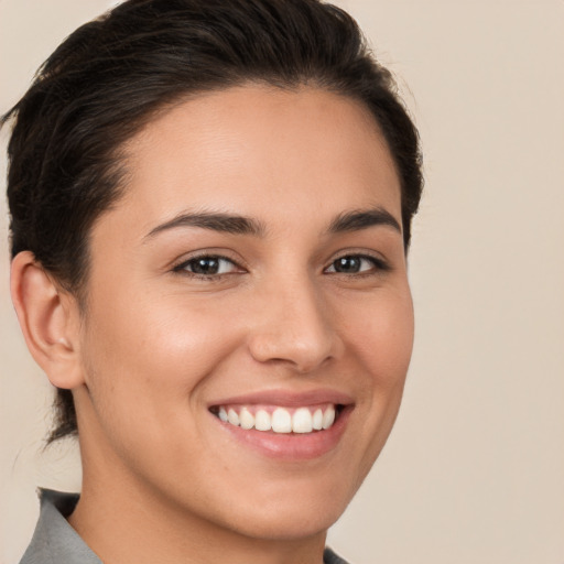 Joyful white young-adult female with short  brown hair and brown eyes