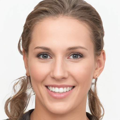 Joyful white young-adult female with long  brown hair and blue eyes