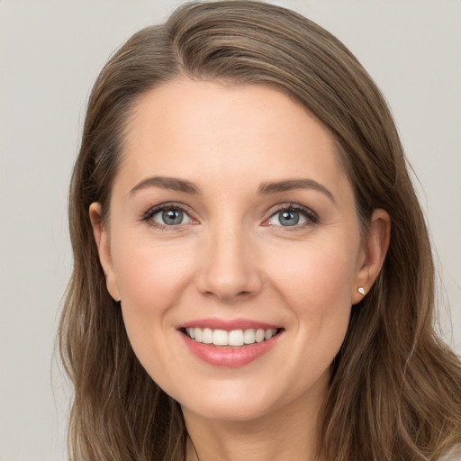 Joyful white young-adult female with long  brown hair and grey eyes