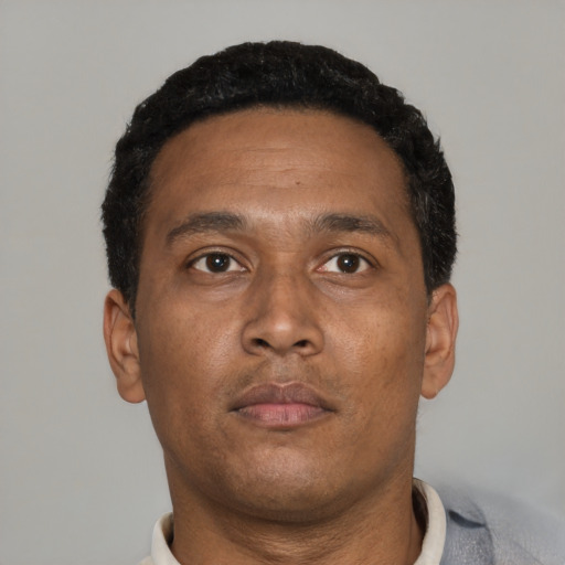 Neutral black adult male with short  black hair and brown eyes