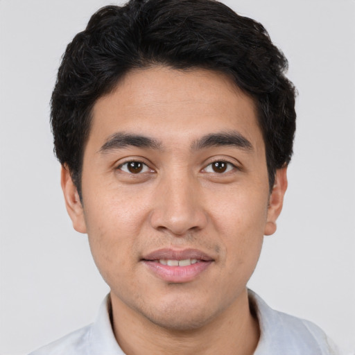 Joyful white young-adult male with short  black hair and brown eyes
