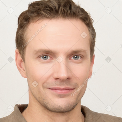 Joyful white young-adult male with short  brown hair and grey eyes