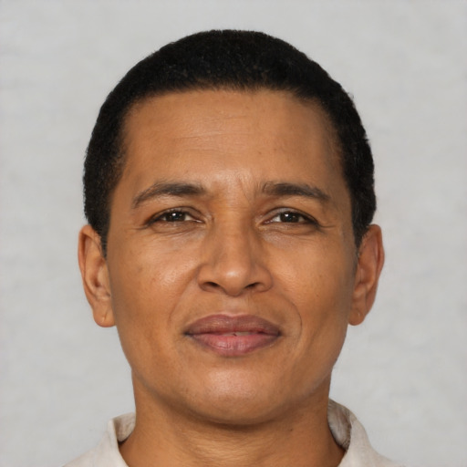 Joyful latino adult male with short  brown hair and brown eyes