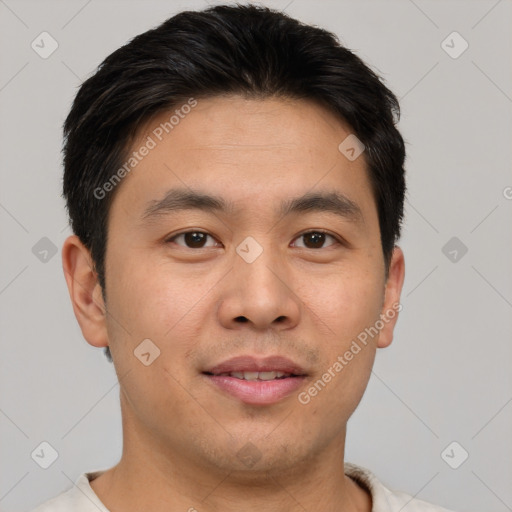 Joyful asian young-adult male with short  brown hair and brown eyes