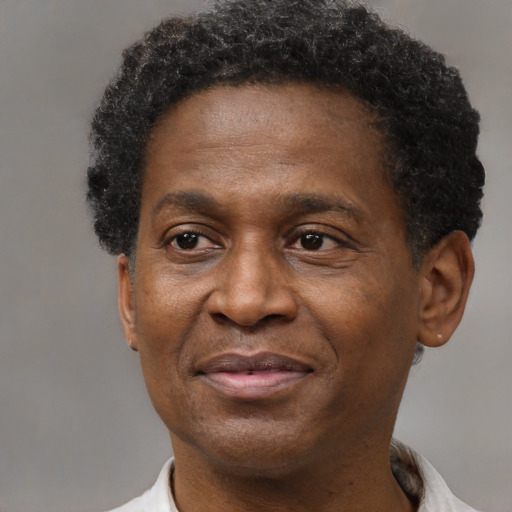 Joyful black adult male with short  brown hair and brown eyes