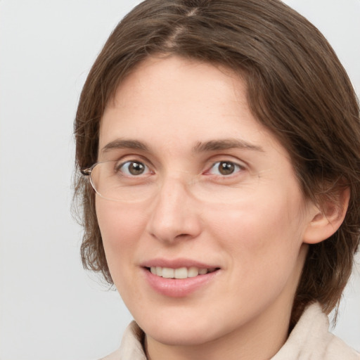 Joyful white young-adult female with medium  brown hair and grey eyes