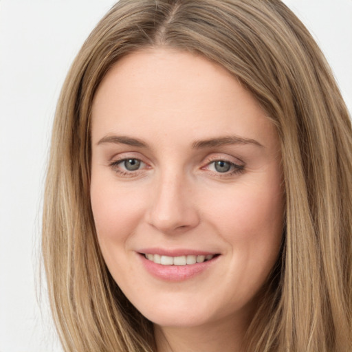 Joyful white young-adult female with long  brown hair and green eyes